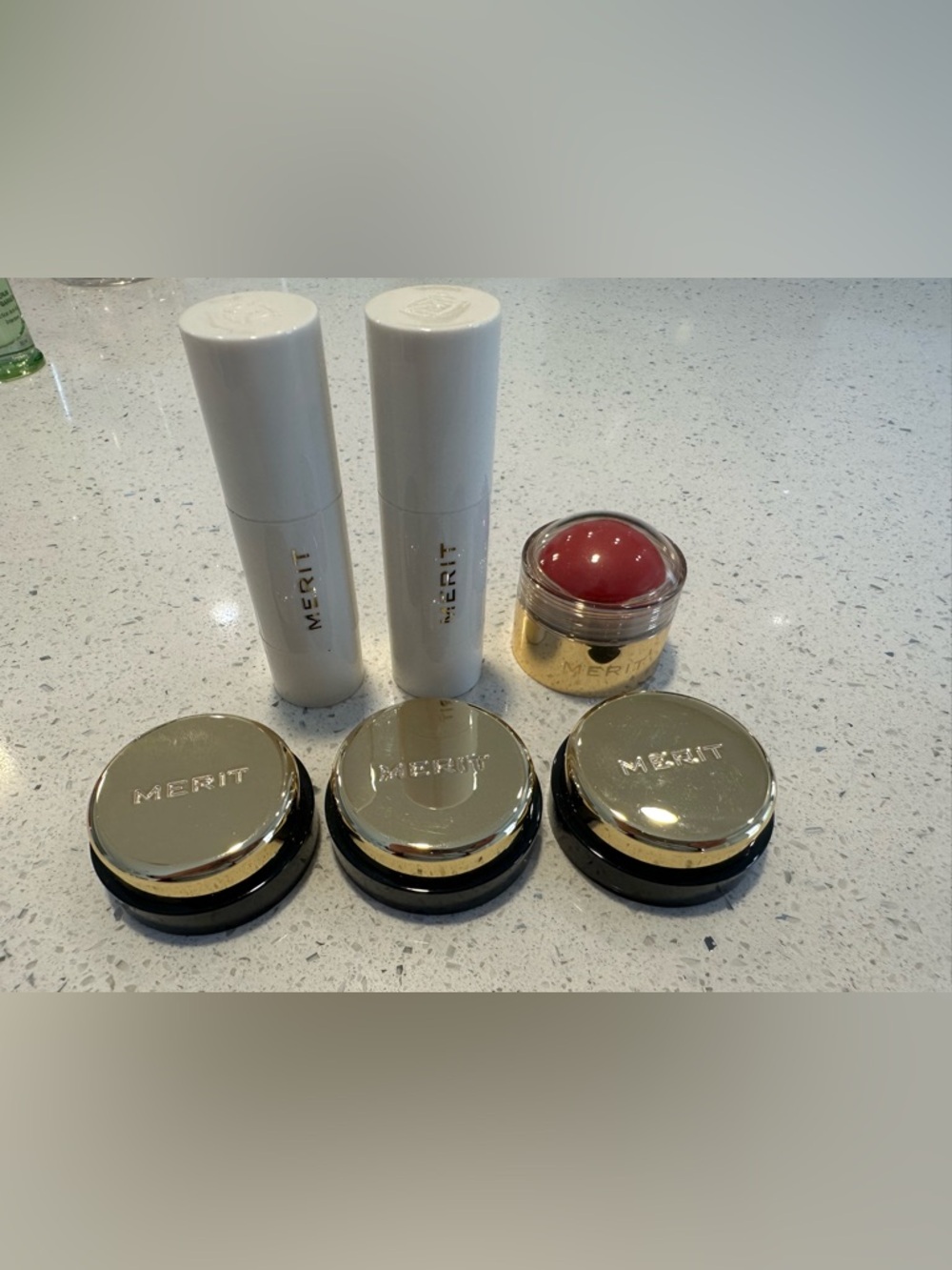 Merit highlighter sticks and eyeshadows